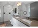A modern bathroom features double sinks, a glass shower, and gray and white finishes at 3 1/2 Maranda Holmes St # B, Charleston, SC 29403