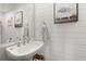 Charming powder room showcases white shiplap walls and a pedestal sink at 3 1/2 Maranda Holmes St # B, Charleston, SC 29403