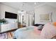 Airy bedroom offers a TV, dresser, mirror, and colorful bedding at 3 1/2 Maranda Holmes St # B, Charleston, SC 29403