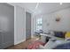 Cozy living room has a grey sofa, and a sunburst wall decoration at 3 1/2 Maranda Holmes St # B, Charleston, SC 29403