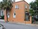 A charming orange house with white trim and a palm tree in front, Charleston, SC at 30 Society St, Charleston, SC 29401