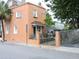 A charming orange home with an attractive iron fence, in a historical neighborhood at 30 Society St, Charleston, SC 29401