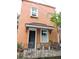 The front porch is enhanced with iron railing and ample plants at 30 Society St, Charleston, SC 29401