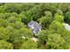 An elevated aerial view of a beautiful property featuring an inground pool amidst a dense forest canopy at 3171 Pignatelli Cres, Mount Pleasant, SC 29466