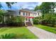 Beautifully landscaped backyard with a charming stone pathway, lush lawn, and mature trees at 3171 Pignatelli Cres, Mount Pleasant, SC 29466