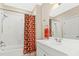 Clean bathroom featuring white vanity, a large mirror, and a shower/tub combination with orange patterned curtain at 3171 Pignatelli Cres, Mount Pleasant, SC 29466