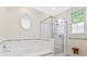 Bright bathroom with a separate tub and shower, complemented by neutral tiles and fixtures for a serene feel at 3171 Pignatelli Cres, Mount Pleasant, SC 29466