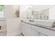 Bathroom featuring double sinks with granite countertops and white cabinetry, offering a clean and modern design at 3171 Pignatelli Cres, Mount Pleasant, SC 29466