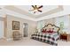 Spacious bedroom with a tray ceiling, multiple windows, and a sitting area, offering a luxurious and airy feel at 3171 Pignatelli Cres, Mount Pleasant, SC 29466