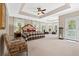 Spacious bedroom with a tray ceiling, multiple windows, and a sitting area, offering a luxurious and airy feel at 3171 Pignatelli Cres, Mount Pleasant, SC 29466