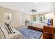 Bedroom with a wooden bed frame, sitting area, and hardwood floors, complemented by natural light, creating an inviting space at 3171 Pignatelli Cres, Mount Pleasant, SC 29466