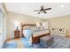 Bright bedroom with a ceiling fan, wooden bed frame, and stylish blue accents, offering a cozy and inviting retreat at 3171 Pignatelli Cres, Mount Pleasant, SC 29466
