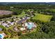 Aerial view showcasing the clubhouse and pool with a slide and various water features surrounded by lush landscaping at 3171 Pignatelli Cres, Mount Pleasant, SC 29466