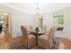 Elegant dining room featuring a glass table, chandelier, and hardwood floors at 3171 Pignatelli Cres, Mount Pleasant, SC 29466