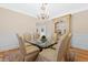 Bright dining room with a glass table, upholstered chairs, and a decorative cabinet at 3171 Pignatelli Cres, Mount Pleasant, SC 29466