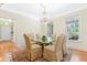 Elegant dining room with hardwood floors, chandelier, and glass-top table, perfect for formal gatherings at 3171 Pignatelli Cres, Mount Pleasant, SC 29466