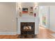Close-up of a fireplace with a white mantel and marble surround, flanked by art and sconces at 3171 Pignatelli Cres, Mount Pleasant, SC 29466