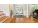 Beautiful foyer with hardwood floors, double glass doors leading to the porch, and classic wainscoting details at 3171 Pignatelli Cres, Mount Pleasant, SC 29466