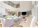 Open-concept living room with staircase, large windows, and stylish decor at 3171 Pignatelli Cres, Mount Pleasant, SC 29466