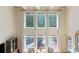 Bright living room features tall windows with a view of the backyard deck at 3171 Pignatelli Cres, Mount Pleasant, SC 29466