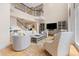 Open-concept living room with staircase, entertainment center, and stylish seating at 3171 Pignatelli Cres, Mount Pleasant, SC 29466
