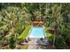 A sparkling pool area with lounge chairs and umbrellas is nestled among mature landscaping at 3171 Pignatelli Cres, Mount Pleasant, SC 29466