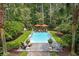Secluded pool area with stylish lounge chairs, umbrellas, and vibrant landscaping at 3171 Pignatelli Cres, Mount Pleasant, SC 29466