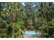 Backyard swimming pool with lounge furniture and shade umbrellas surrounded by lush greenery at 3171 Pignatelli Cres, Mount Pleasant, SC 29466