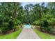 Lush backyard oasis with a sparkling pool, manicured landscaping, and charming stone pathway at 3171 Pignatelli Cres, Mount Pleasant, SC 29466