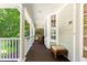 Spacious porch with wicker furniture, white columns, and view of the manicured lawn, perfect for outdoor relaxation at 3171 Pignatelli Cres, Mount Pleasant, SC 29466
