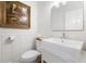 Stylish powder room with a modern square sink, white wainscoting, and elegant artwork, creating a sophisticated space at 3171 Pignatelli Cres, Mount Pleasant, SC 29466