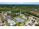 Aerial view showcasing the community tennis courts and pool areas, surrounded by lush green trees and landscaping at 3171 Pignatelli Cres, Mount Pleasant, SC 29466