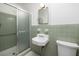 Neutral bathroom with a shower, white toilet, green tile accents, and a framed mirror at 344 Canterbury Rd, Charleston, SC 29407