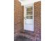 Brick entrance with a glass-paned door and a metal handrail for added safety at 344 Canterbury Rd, Charleston, SC 29407