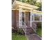 Close-up of a decorative brick front porch with white metal supports and steps leading to the front door at 344 Canterbury Rd, Charleston, SC 29407