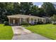Classic brick home featuring a covered carport and inviting front yard, exuding curb appeal at 344 Canterbury Rd, Charleston, SC 29407