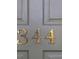 Close-up of the house number '344' in gold lettering on a grey door at 344 Canterbury Rd, Charleston, SC 29407