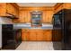 Functional kitchen with wood cabinets and a black appliance suite at 344 Canterbury Rd, Charleston, SC 29407