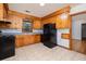Efficient kitchen featuring wood cabinetry and black appliances at 344 Canterbury Rd, Charleston, SC 29407