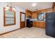 Cozy kitchen featuring tile floors, wood cabinets, and black appliances at 344 Canterbury Rd, Charleston, SC 29407