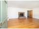 Bright living room with original hardwood floors, a brick fireplace, and neutral walls at 344 Canterbury Rd, Charleston, SC 29407