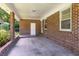 Covered brick patio with supporting pillars and ample space for entertaining or relaxing at 344 Canterbury Rd, Charleston, SC 29407