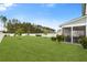 Well-kept backyard with a screened-in porch and lush lawn, perfect for outdoor living and entertaining at 347 Ripple Park Dr, Summerville, SC 29486