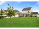 Spacious backyard with a screened-in porch, young trees, and lush green lawn, perfect for outdoor enjoyment at 347 Ripple Park Dr, Summerville, SC 29486