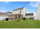 Beautifully landscaped backyard with a screened-in porch, patio, and lush greenery, ideal for entertaining at 347 Ripple Park Dr, Summerville, SC 29486