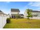 Lush backyard with screened porch, well-kept lawn, and privacy fencing at 347 Ripple Park Dr, Summerville, SC 29486