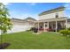 Lush backyard with screened porch, well-kept lawn, and privacy fencing at 347 Ripple Park Dr, Summerville, SC 29486