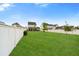 Expansive backyard with lush green grass, white picket fence, and young trees, perfect for outdoor activities at 347 Ripple Park Dr, Summerville, SC 29486
