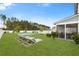 Manicured backyard with a small pool, lounge chairs, and a screened-in porch perfect for relaxing outdoors at 347 Ripple Park Dr, Summerville, SC 29486