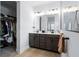 Bathroom featuring a double sink vanity, walk-in closet, and a glass-enclosed shower with a neutral palette at 347 Ripple Park Dr, Summerville, SC 29486